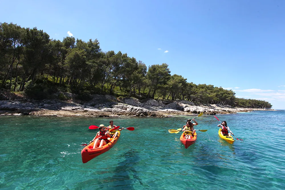 Sea kayaking along the clear-water coast of Brač Island, Croatia